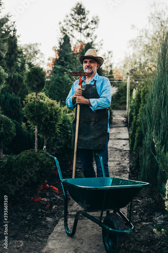 middle aged man posing nursery garden