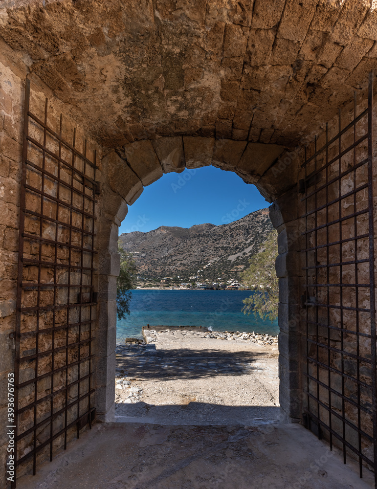 Leper's gate among the ruins of the venetian fortress on the island of Spinalonga, Gulf of Elounda, Lasithi, Crete, Greece. It was used as a leper colony from 1903 to 1957