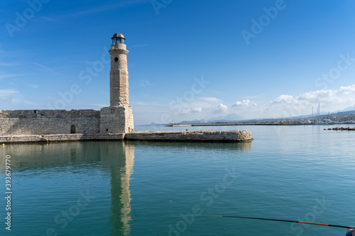 The iconic lighthouse of the old Venetian harbor of Rethymno (also Rethimno, Rethymnon, and Rhithymnos) on the north coast of Crete, Greece.
