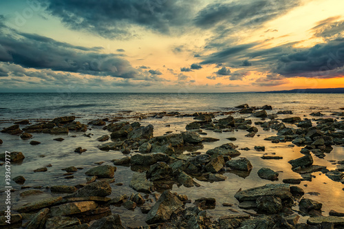 Schilderij op canvas Stone beach at sunset
