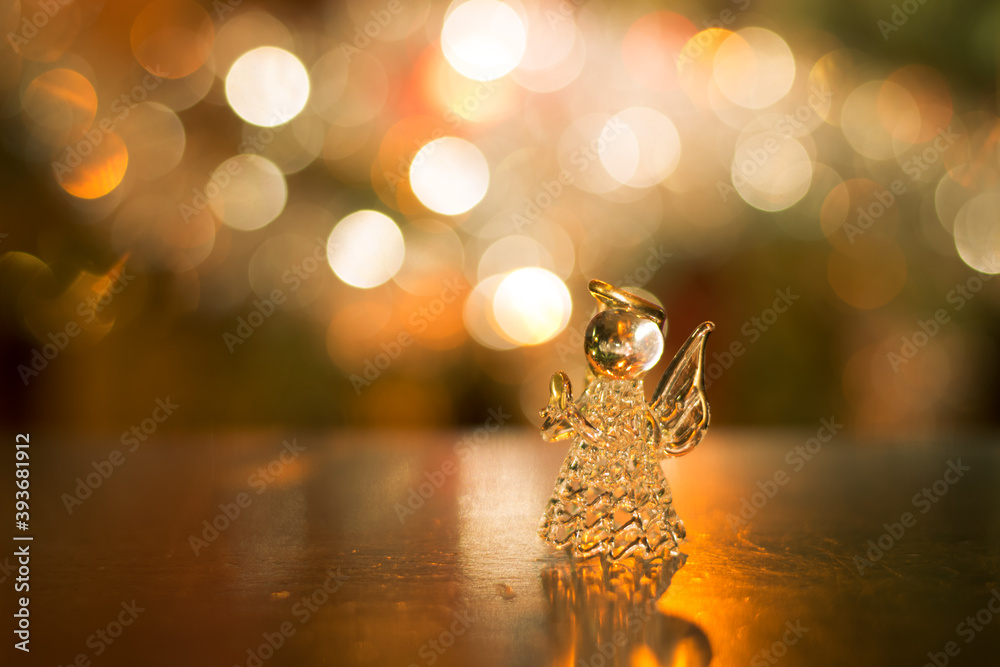 glass angel in luxurious bokeh shining christmas background