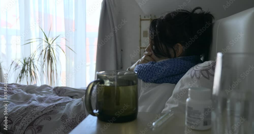 Sick Upset Sad Woman is Coughing. Woman Rests Lying in Bed in front of