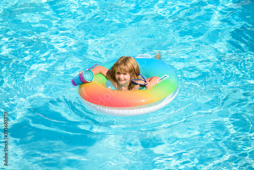 Summer vacation fun. Happy child playing in swimming pool. Top view portrait.