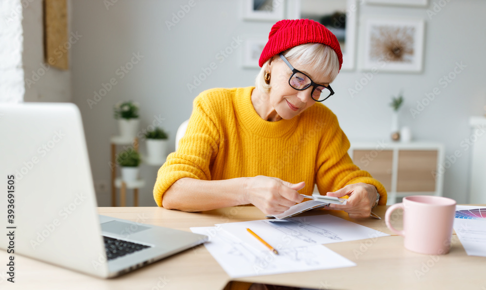 Happy senior freelancer reading papers. Happy senior freelancer reading papers.