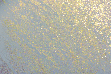 Abstract light gray background with golden glitter. Holiday decoration concept. Place for text.