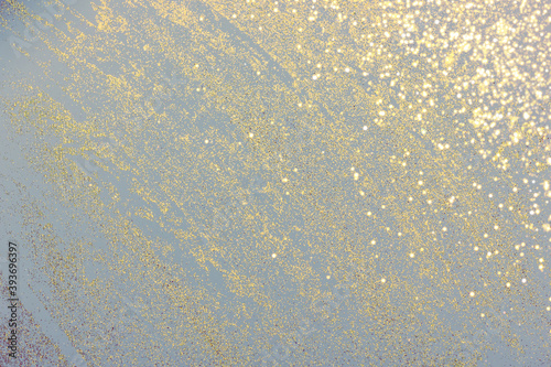 Abstract light gray background with golden glitter. Holiday decoration concept. Place for text.