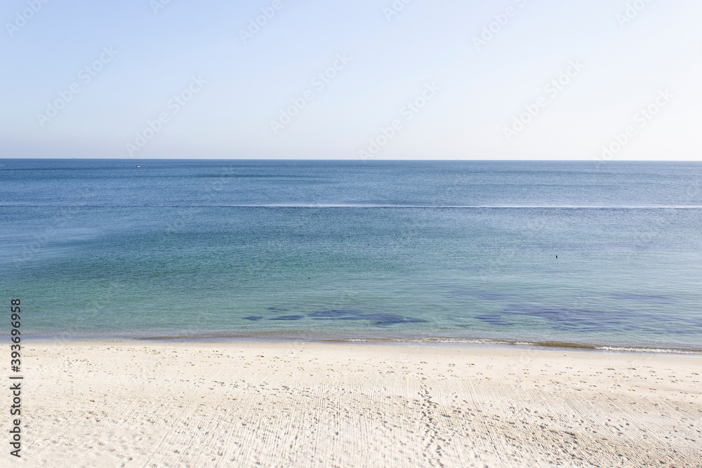 Abstract calm blue sea water horizon with light sand beach and sky wild nature beauty 