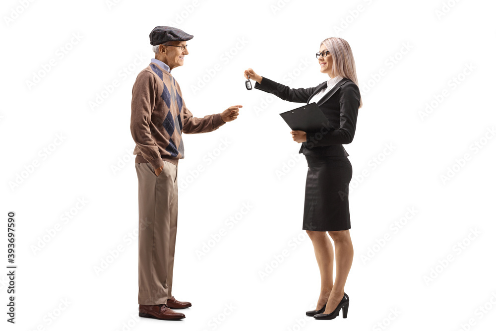 Obraz premium Full length profile shot of a professional woman giving car keys to an elderly man