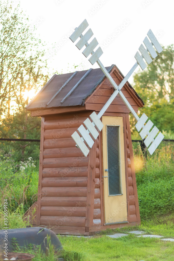 Rustic outdoor toilet in the form of a windmill Rustic outdoor toilet in the form of a windmill