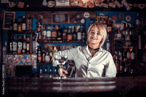 Girl barman creates a cocktail on the porterhouse
