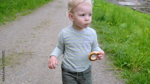 The first steps of the child. Walk in the park. Slow motion.