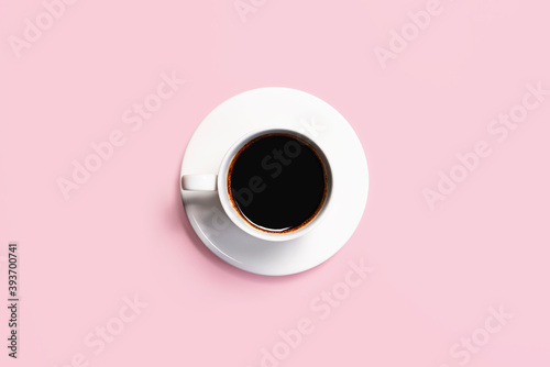 Cup of coffee on a pink background. Coffee cup top view.