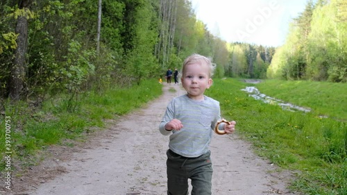 The first steps of the child. Walk in the park. Slow motion.