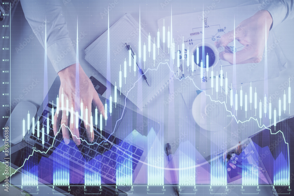 Multi exposure of man's hands typing over computer keyboard and forex graph hologram drawing. Top view. Financial markets concept. Multi exposure of man's hands typing over computer keyboard and forex graph hologram drawing. Top view. Financial markets concept.