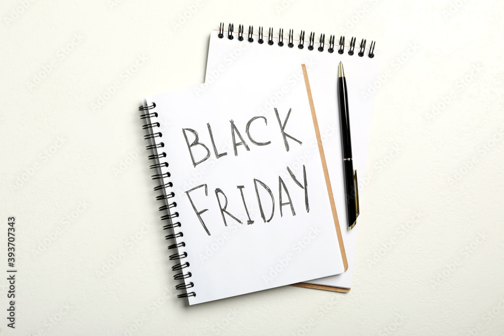 Notebook with phrase Black Friday on white background, flat lay Notebook with phrase Black Friday on white background, flat lay