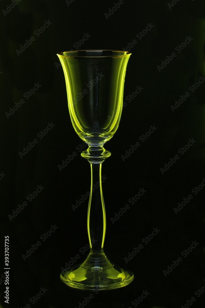 empty glass wine glass on a black background with green highlights empty glass wine glass on a black background with green highlights