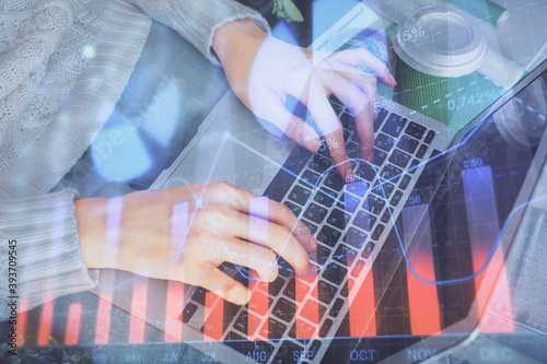 Double exposure of woman hands typing on computer and forex chart hologram drawing. Stock market invest concept.