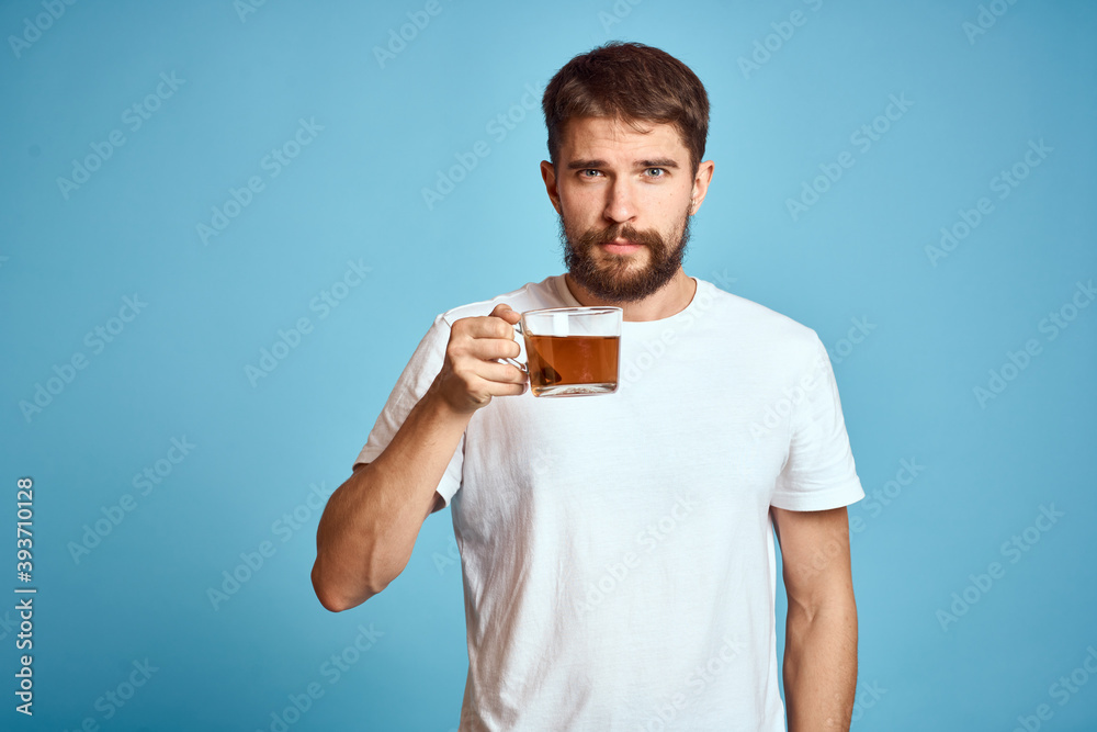 Man with a cup of tea on blue background cropped view of fun emotion Copy Space Man with a cup of tea on blue background cropped view of fun emotion Copy Space