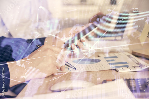 Double exposure of man's hands holding and using a digital device and forex graph drawing. Financial market concept.