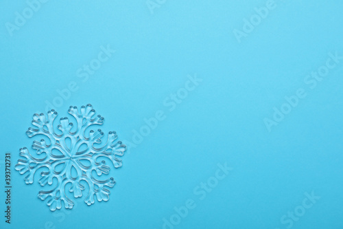 Beautiful decorative snowflake on light blue background, top view. Space for text