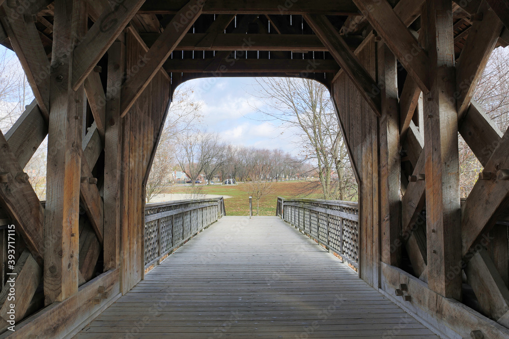 Interior of covered bridge with opening at the end.