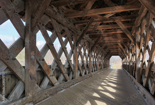 Interior of covered bridge with opening at the end.