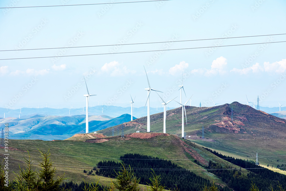 Wind turbines under blue skies