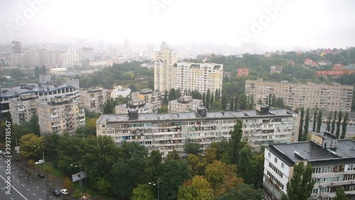 Aerial, high angle, focus rack, racking view on Kiev Railway main station area, houses, buildings, apartment complexes, houses, homes in Kyiv in morning, rain, raining, road street, cars in Ukraine photo