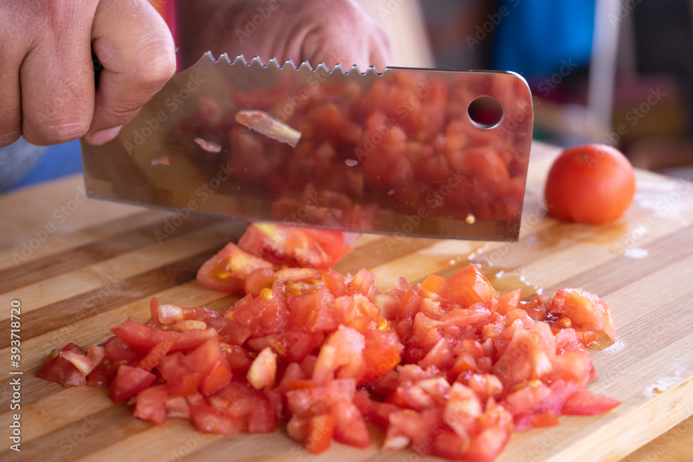 chopping tomatoes for cooking