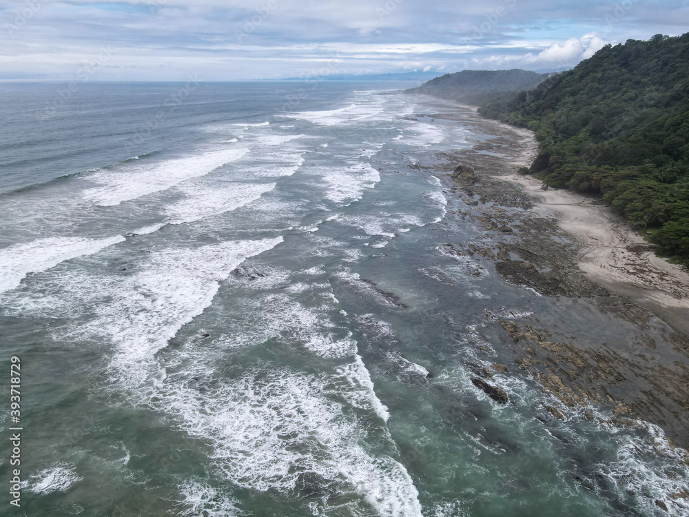 	
Lush Tropical Beach Paradise with blue water, great waves and rock formations in Malpais / Santa Teresa, Nicoya Peninsula Costa Rica	
