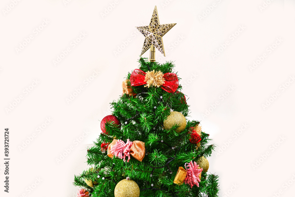 Christmas tree with beautiful decoration of spheres and topknots and a star on top.