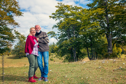 Senior couple on a walk in an autumn nature.