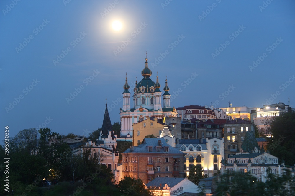 St. Andrew's Church was built in the Baroque style in 1749-1754 by the architect Rastrelli.  It is located on Andreevskaya Hill above the historical part of Podol.  Full Moon. Kiev city.