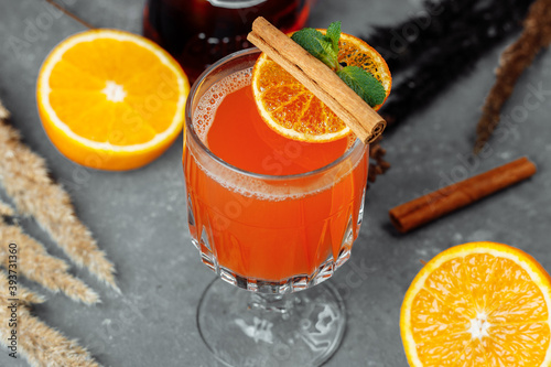 Warming winter cocktail with aperol. Hot aperol. Cocktail For New Years and Christmas. Christmas winter cocktail with aperol spritz martini pineapple juice and spices