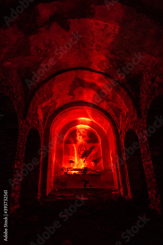 inside abandoned dark church in spain illuminated with red light