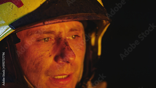 Portrait shot of a fireman in helmet. . High quality photo