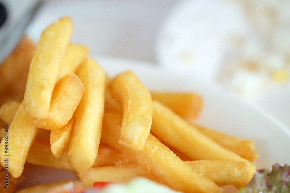 Close up French fries in a white dish on the table Close up French fries in a white dish on the table