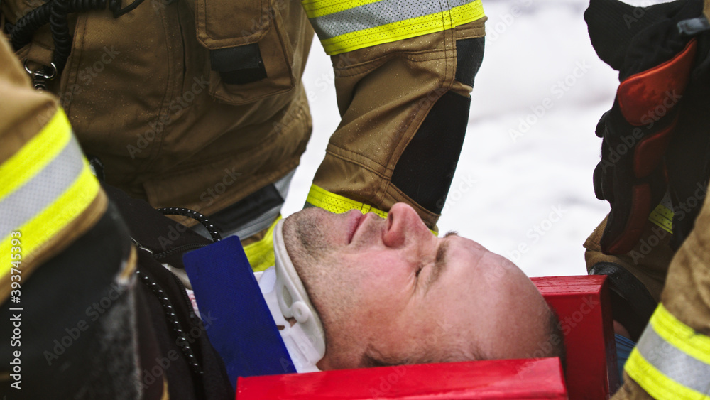 Firefghters lifting injured man. Rescue after car crash accident. High quality photo Firefghters lifting injured man. Rescue after car crash accident. High quality photo