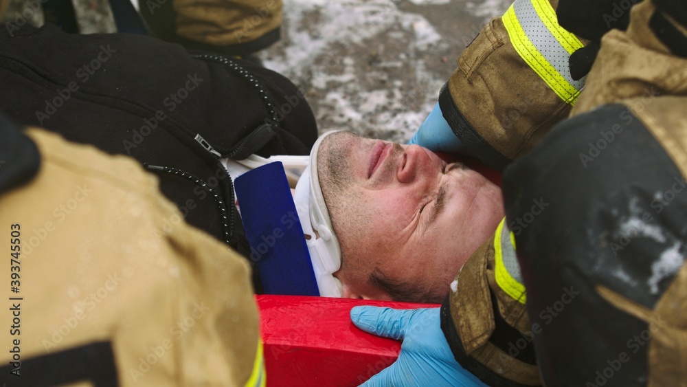 Firefghters lifting injured man. Rescue after car crash accident. High quality photo Firefghters lifting injured man. Rescue after car crash accident. High quality photo