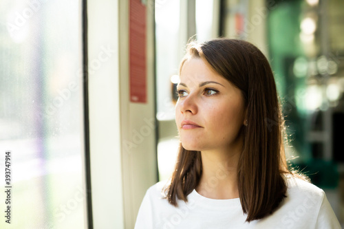 Young woman in casual clothing traveling in public transport