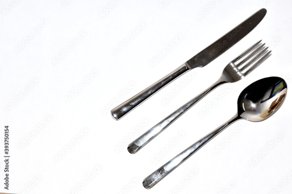 Cutlery Silverware Set with Spoons, forks, steak knives isolated on white background with copy space. Selective Focus. Cutlery Silverware Set with Spoons, forks, steak knives isolated on white background with copy space. Selective Focus.