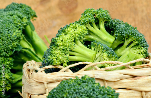 healthy and benefits of Broccoli. .a lot of broccoli in basket on wooden background.