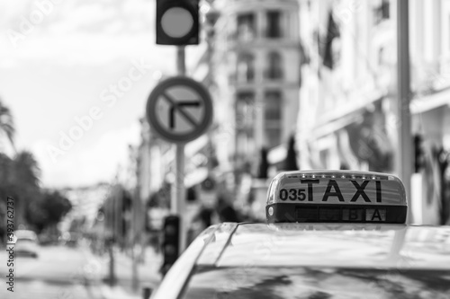 Nice, France, October 8, 2019. Urban view. Taxi car on the background of Promenade des Anglais embankment. 