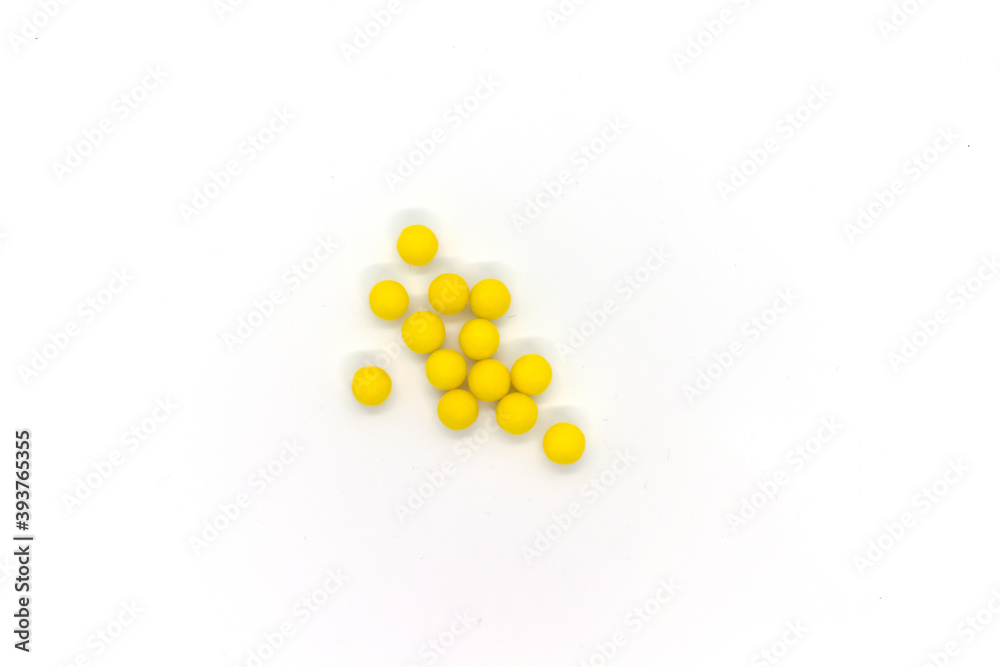 Round yellow pills isolated items on white background. Top view