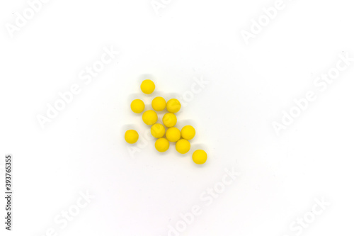 Round yellow pills isolated items on white background. Top view