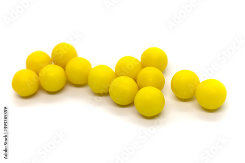 Round yellow pills isolated items on white background