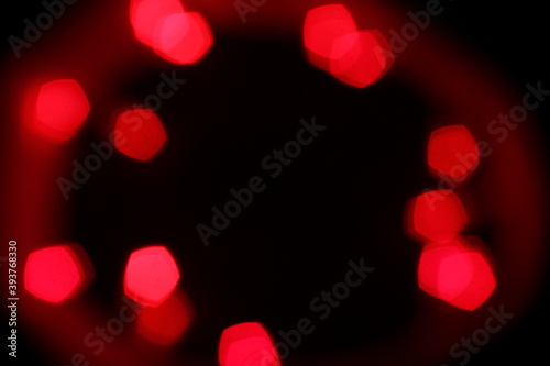 Red bokeh lights on a black background. Christmas lights texture for design