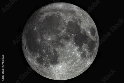 Large photo of the moon through a telescope. Moon with high magnification. Lunar surface with craters.
