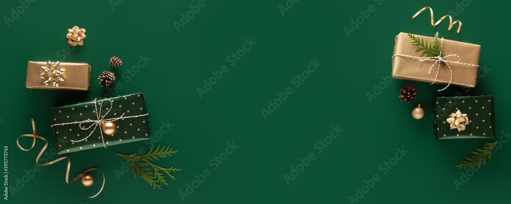 Christmas banner. Gifts in wrapping paper on green background. Copy space. Christmas banner. Gifts in wrapping paper on green background. Copy space.