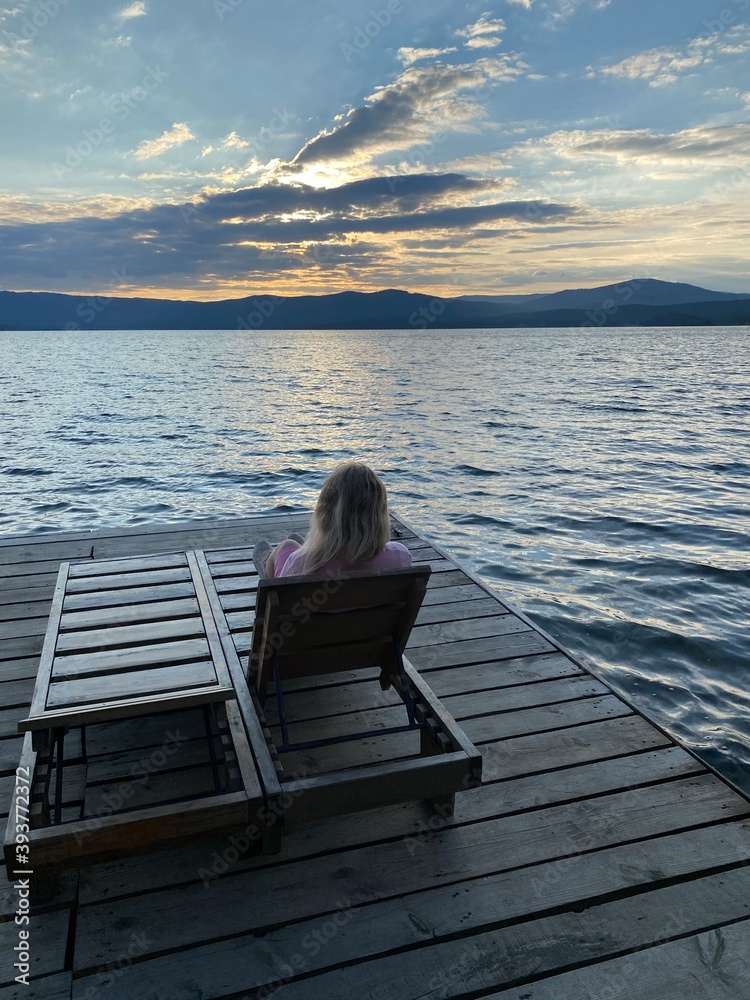 person sitting on a pier